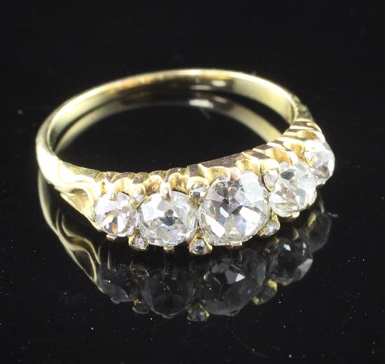 An 18ct gold five stone diamond ring, size M.